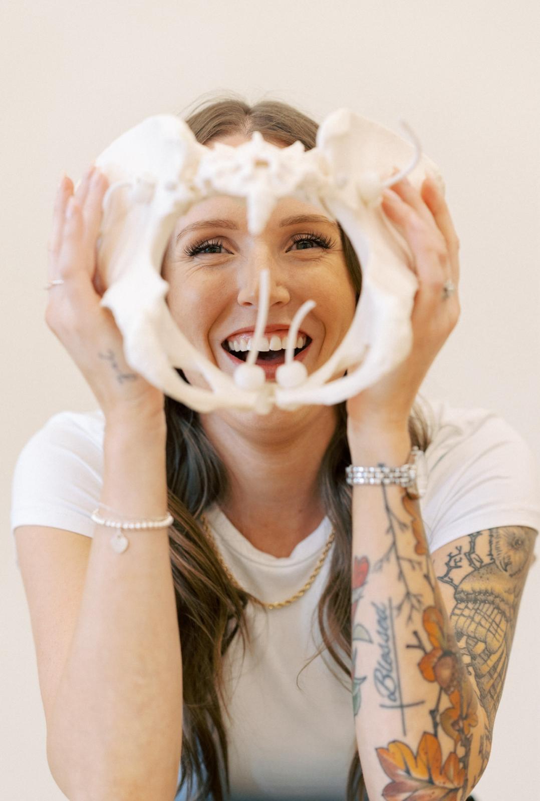Danita laughing behind a model pelvis
